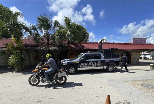 A police vehicle is parked outside the restaurant the day after a fatal shooting in Tulum, Mexico, Friday, Oct. 22, 2021.  (AP Photo/Christian Rojas)
