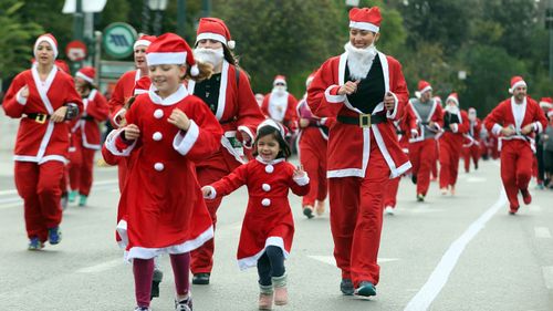Hundreds of people took party in the third Santa run in Athens, Greece. (AAP)