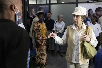 Princess Anne, right, greets clients of the Opportunity Bank branch that she officially opened in Nakivale refugee settlement, in southwestern Uganda, Wednesday, Oct. 26, 2022.