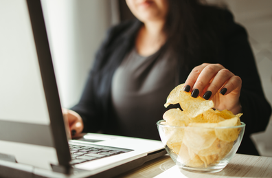 Woman reaching for potato chips