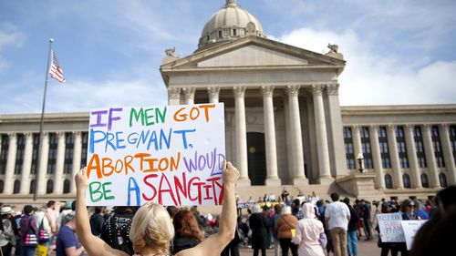 A person holds a sign during the Bans Off Oklahoma Rally on the steps on Oklahoma state Capitol to protest against the state's abortion bill.