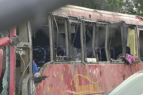 A damaged bus is shown after several people were killed and dozens injured after the commercial bus overturned on Interstate 20 early Saturday, Aug. 31 2024 in Warren County, Miss., according to the Mississippi Highway Patrol. (WAPT via AP)