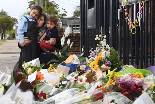 People have laid tributes outside the school.