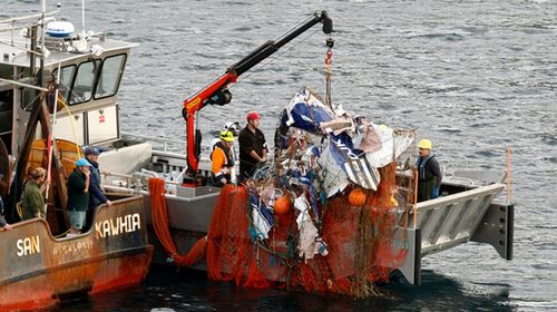 New Zealand fishing trawler hauls up plane containing body