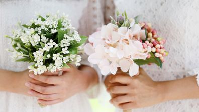 Asian girls holding wedding bouquet