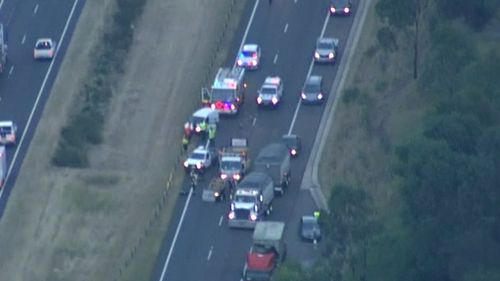 Emergency services are at the scene of the fatal crash on the M7 at Cecil Hills. (9NEWS)