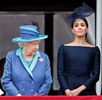 LONDON, UNITED KINGDOM - JULY 10: (EMBARGOED FOR PUBLICATION IN UK NEWSPAPERS UNTIL 24 HOURS AFTER CREATE DATE AND TIME) Queen Elizabeth II and Meghan, Duchess of Sussex watch a flypast to mark the centenary of the Royal Air Force from the balcony of Buckingham Palace on July 10, 2018 in London, England. The 100th birthday of the RAF, which was founded on on 1 April 1918, was marked with a centenary parade with the presentation of a new Queen's Colour and flypast of 100 aircraft over Buckingham 