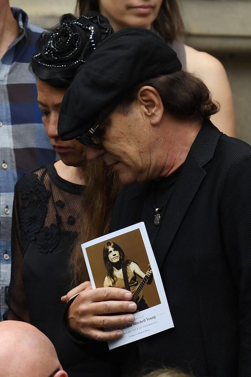 Lead singer Brian Johnson clutches an order of service. Picture: AAP