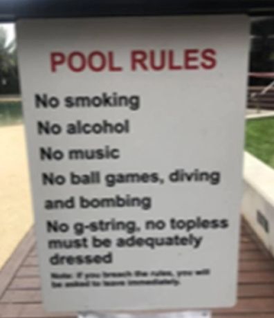 A sign displayed in the pool area at the building.