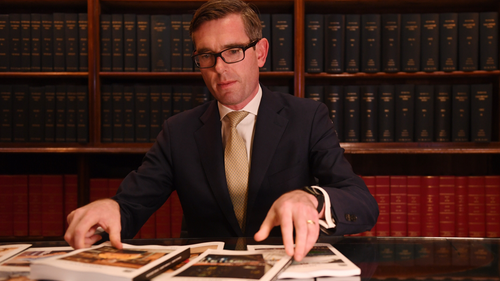 NSW Treasurer Dominic Perrottet looks over the 2019/20 budget papers.