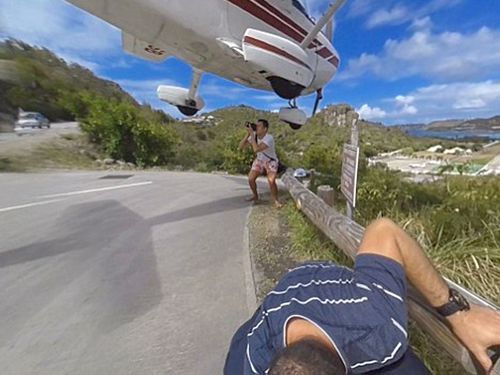 Tourist clipped by landing plane as he takes photo of super-close descent