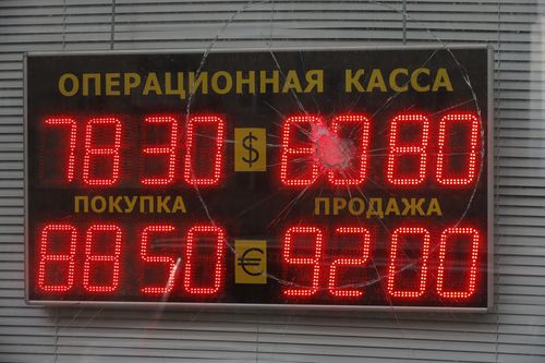An exchange office screen is seen through a damaged glass shows the currency exchange rates of U.S. Dollar and Euro to Russian Rubles in Moscow, Russia, Tuesday, Feb. 22, 2022. The United States holds one of the most powerful financial weapons to wield against Putin if he invades Ukraine's blocking Russia from access to the U.S. dollar. Dollars still dominate in financial transactions around the world, with trillions of dollars in play daily.(AP Photo/Alexander Zemlianichenko Jr)