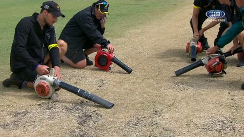 Ground staff were forced to deploy vacuum blowers in a bid to dry the pitch.