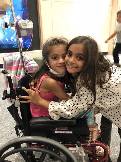 Meesha (left) during one of her many hospital stays as a young child.