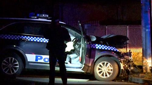 The patrol car crashed into a telegraph pole.