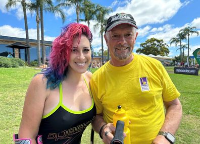 Lucy Woolfman poses in her swimsuit with a friend.