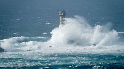 Waves break on Longships lighthouse off the coast of Lands End, southwestern England. (AP)