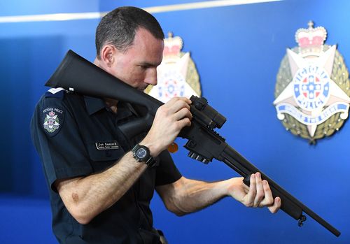 A Victorian Police officer handles an illegal gun seized by authorities last year. Under a new plan, officers could soon have access to military-style semi-automatic weapons to combat terror. (AAP)