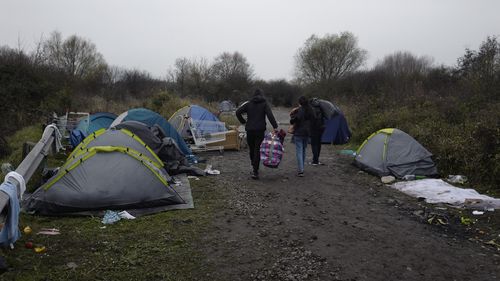 A migrants makeshift camp is set up along the river in Loon Plage, near Grande-Synthe, northern France, Friday, Nov. 26, 2021