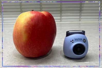 9PR: Instax Pal Camera beside an apple for size reference.