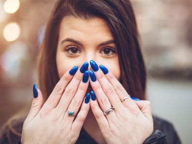 Woman with long painted nails.