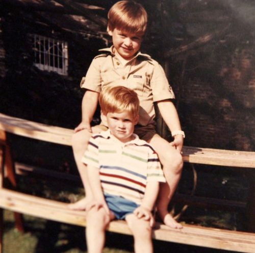 Prince William and Prince Harry sit on a picnic bench together. (Kensington Palace)