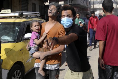 Injured Palestinians are evacuated following Israeli airstrikes on town of Khan Younis, southern Gaza Strip, Thursday, Oct. 26, 2023.