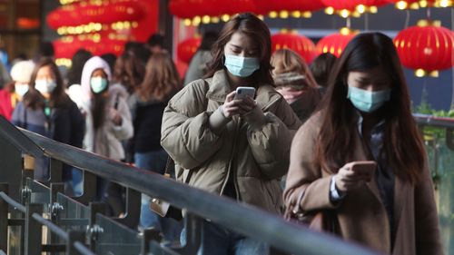 People wear face masks and walk at a shopping mall in Taipei, Taiwan.