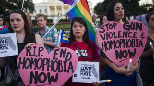 Members and supporters of the lesbian, gay, transgender, bisexual and queer (LGTBQ) community attend a candlelight vigil outside the White House to honor the victims of the mass shooting at Pulse. (EPA/Jim Lo Scalzo)