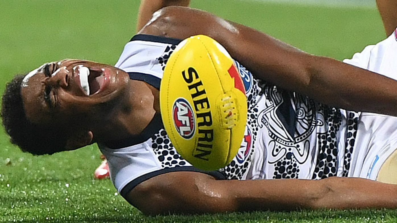 Geelong youngster Esava Ratugolea goes down with a suspected broken leg