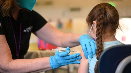 A nurse administers a pediatric dose of the Covid-19 vaccine to a girl at a L.A. Care Health Plan vaccination clinic at Los Angeles Mission College in the Sylmar neighborhood in Los Angeles, California, January 19, 2022 