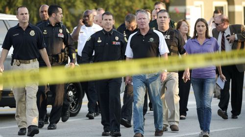 Orlando Mayor Buddy Dyer, center right, and Orlando Police Chief John Mina, center left, arrive to a news conference on Sunday. (AP/Phelan M. Ebenhack)