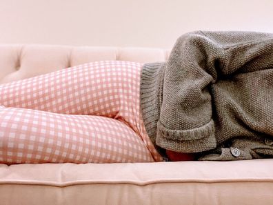 Woman lying down due to period pain.