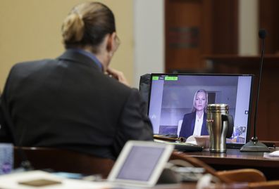 Model Kate Moss, a former girlfriend of actor Johnny Depp, testifies via video link at the Fairfax County Circuit Courthouse in Fairfax, Va., Wednesday, May 25, 2022, as Depp looks on.  