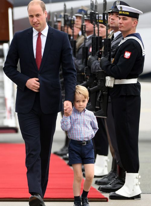 Prince George shies away from the cameras with his father Prince William. (AAP)