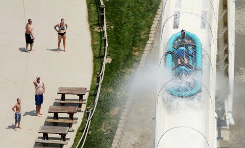 In this July 9, 2014 file photo, riders are propelled by jets of water as they go over a hump while riding a water slide called "Verruckt" at Schlitterbahn Water Park in Kansas City, Kan. The water park plans to tear down a giant water slide on which a 10-year-old boy died in 2016. The Kansas City Star reports an attorney representing an affiliate of Kansas City, Kansas, park operator Schlitterbahn said Thursday, July 12, 2018, that the 17-story slide called Verruckt would start coming down about a week after Labor Day. (AP Photo/Charlie Riedel, File)