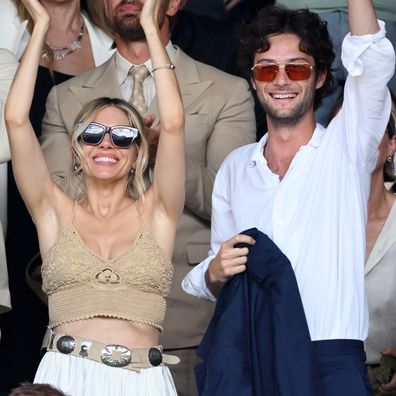 Sienna Miller and Oli Green on day 14 of the Wimbledon Tennis Championships at the All England Trennis and Croquet Club at on July 13, 2025 in London, England.