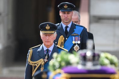 King Charles III and Prince William, Prince of Wales walk behind the gun carriage bearing the coffin of the late Queen Elizabeth II as it departs Buckingham Palace, transferring the coffin to The Palace of Westminster on September 14, 2022 in London, United Kingdom. 