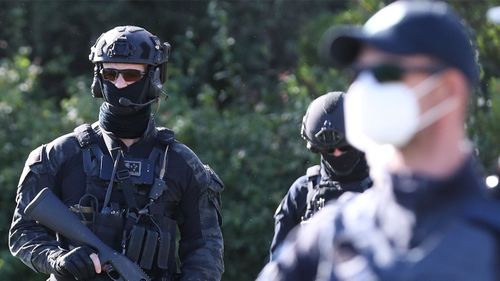 Police enter the makeshift campsite associated with the 'Convoy to Canberra'.