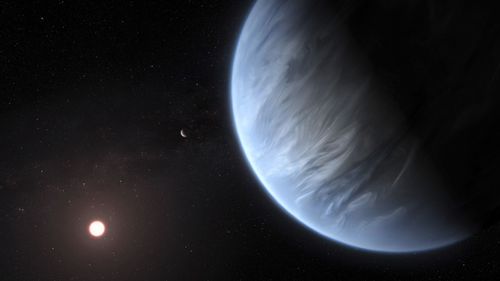 Exoplanet K2-18b, foreground, its host star and an accompanying planet in this system. On Wednesday, the scientists announced they discovered water on the planet outside our solar system that has temperatures suitable for life. (M. Kornmesser/ESA/Hubble via AP)