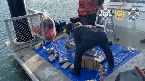 A group of 13 men, including two minors, have been charged as part of the largest-ever cocaine bust in Australia.