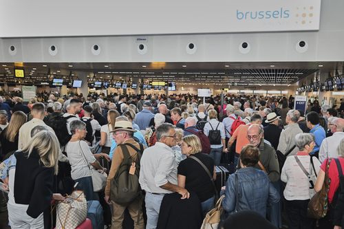Brüksel Uluslararası Havalimanı'nda yolcular check-in yapmak için sırada bekliyor.