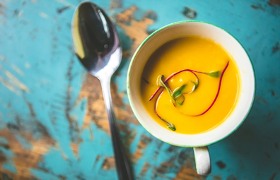 Healthy pumpkin soup in a cup