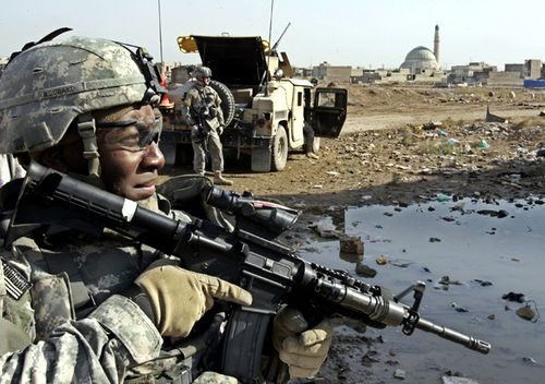 In this 2006 photo a US Army soldier from the 2nd Infantry Battalion, 17th Field Artillery Regiment looks on before the start of a mission to monitor a mosque during Friday prayers in Baghdad, Iraq.