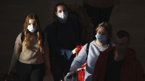 Travellers in protective masks in Israel.