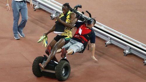 Usain Bolt is taken out by a cameraman on a Segway.