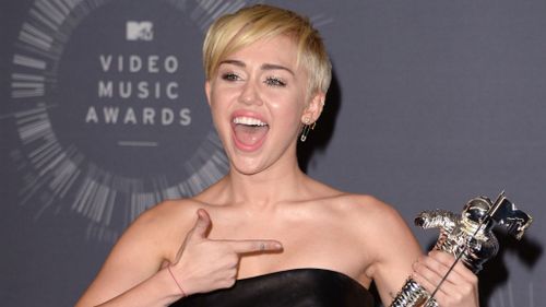 Miley Cyrus shows off her MTV award for Video of the Year. The award was accepted on her behalf by Jesse. (AP)