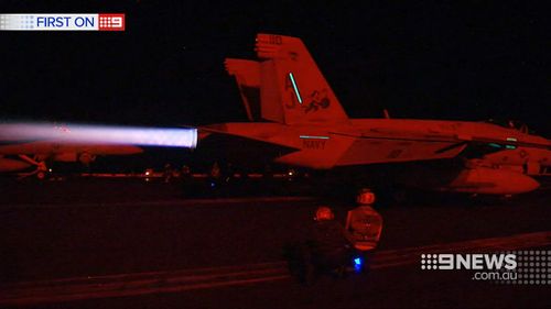 The cycle of jets landing and taking off continues through the night. (9NEWS)