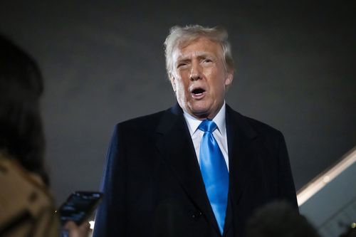 President Donald Trump speaks to reporters next to Air Force One after arriving back at Joint Base Andrews.