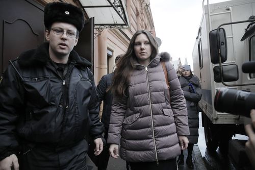 Alla Ilyina is escorted by a bailiffs form a court after a session in St.Petersburg.